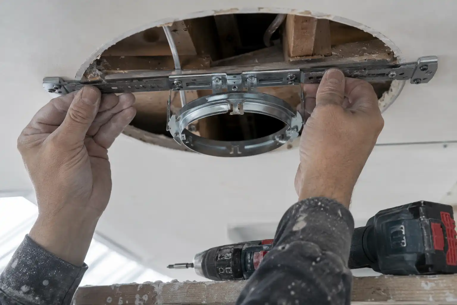 Installing a ceiling brace bar and fixture strap to support a heavy salvaged brass pendant