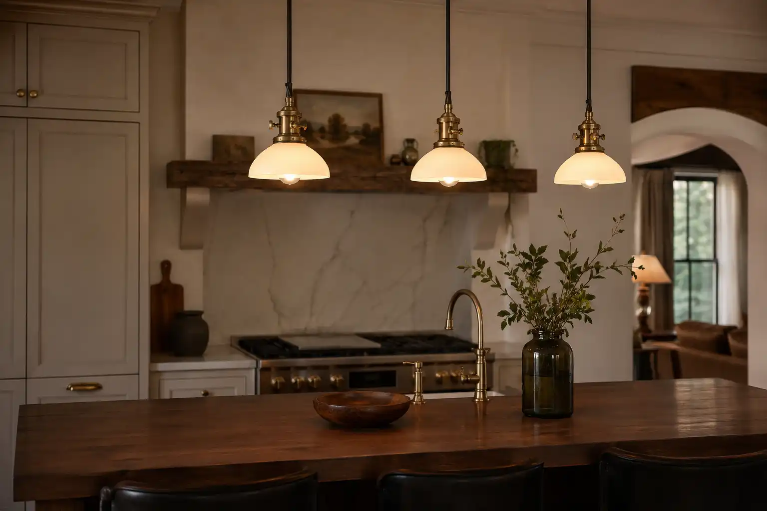 Three reclaimed brass ship pendants hung over a walnut island, salvaged in Chattogram Bangladesh