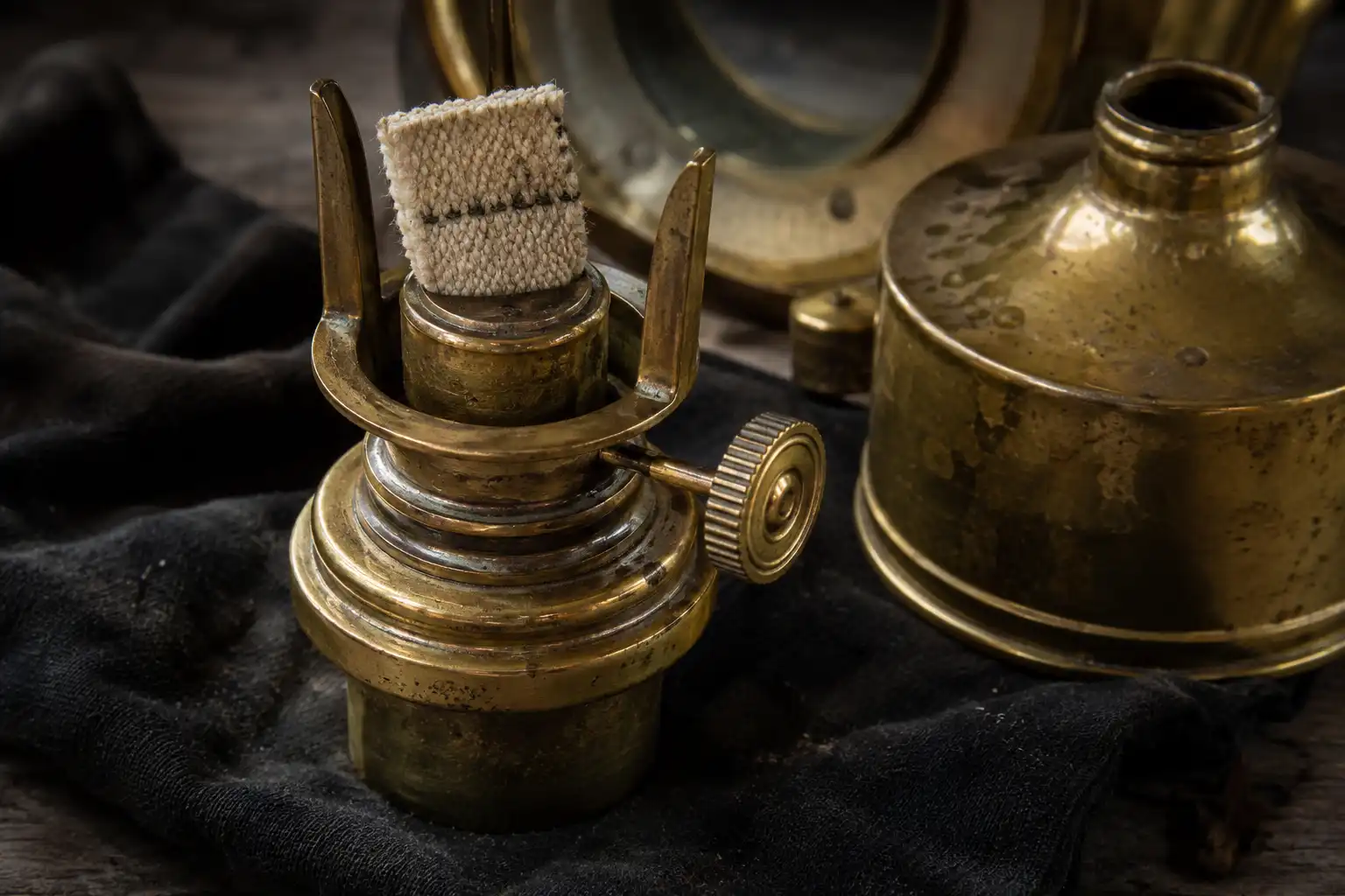 Close-up of a brass oil burner and cotton wick removed from a vintage marine lantern in Chattogram