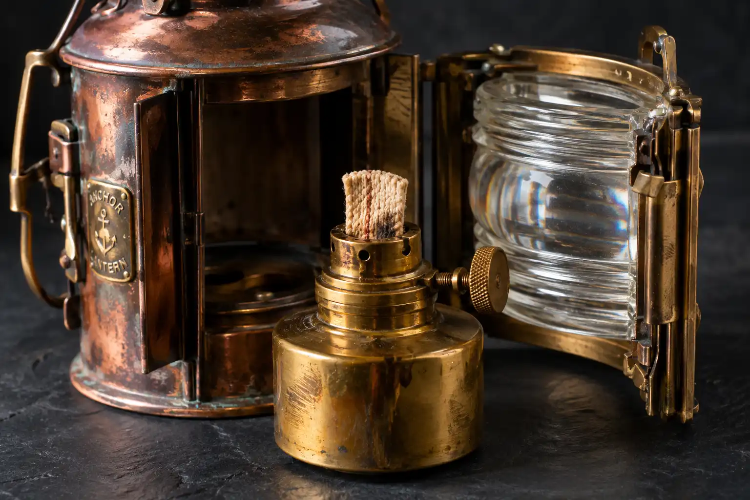 Close view of a vintage anchor lantern oil font, wick burner and Fresnel lens salvaged in Chattogram, Bangladesh