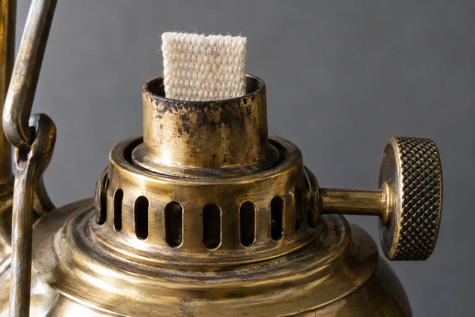 Close up of a trimmed flat cotton wick inside a brass marine lantern burner ready for kerosene
